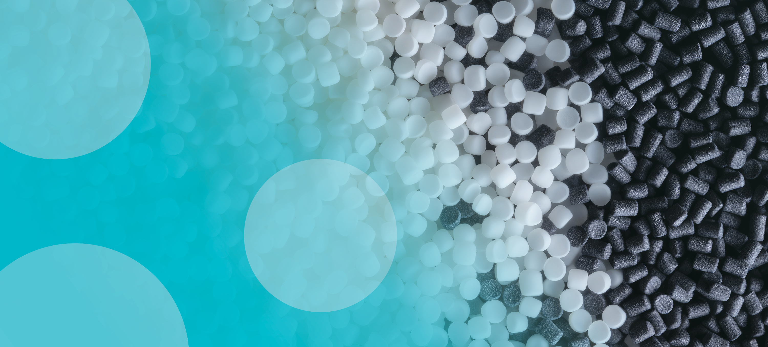 Close-up of white and black plastic polymer pellets used as raw materials in plastic manufacturing