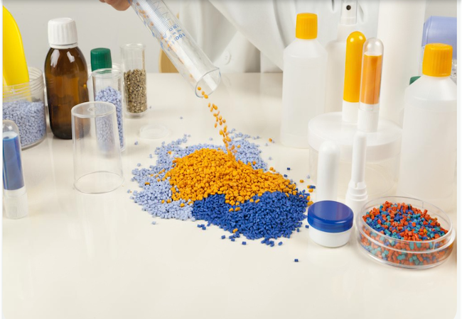 Plastic pellets and laboratory containers on a worktable