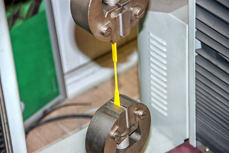 Material sample stretched in a laboratory tensile testing machine